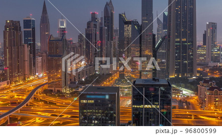 Panorama of Dubai Financial Center district with tall skyscrapers with illumination night to day timelapse. 96800599