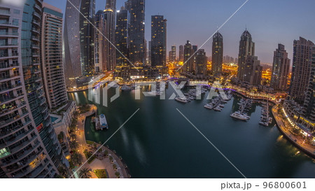 Dubai marina tallest skyscrapers and yachts in harbor aerial night to day timelapse. 96800601