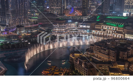 Dubai Fountain aerial night timelapse. Musical fountain, located in an artificial lake in downtown Dubai Fountain aerial night timelapse. Musical fountain, located in an artificial lake in downtown 96800664