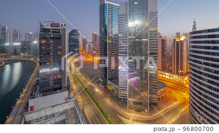 Cityscape of skyscrapers in Dubai Business Bay with water canal aerial night to day timelapse Cityscape of skyscrapers in Dubai Business Bay with water canal aerial night to day timelapse 96800700