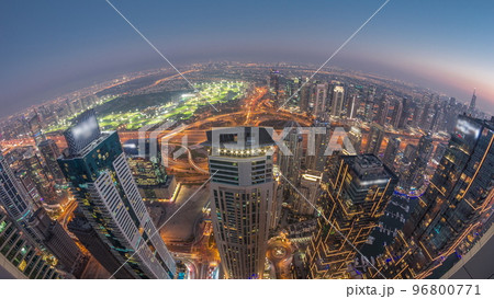 Panorama of Dubai Marina with JLT skyscrapers and golf course day to night timelapse, Dubai, United Arab Emirates. Panorama of Dubai Marina with JLT skyscrapers and golf course day to night timelapse, Dubai, United Arab Emirates. 96800771