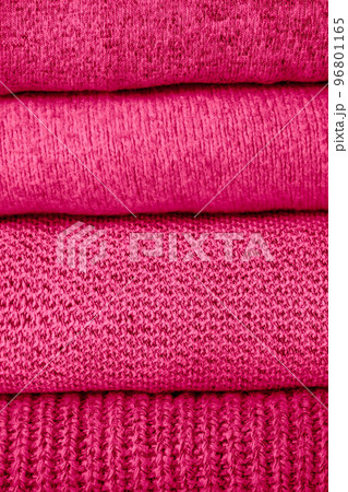 stack of magenta knit sweaters 96801165