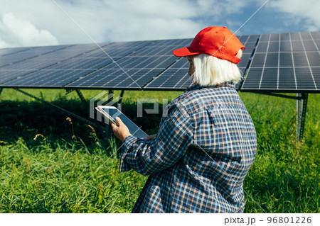 Inspector engineer woman with digital tablet working at solar power plant, photovoltaic park, green energy concept. Inspector engineer woman with digital tablet working at solar power plant, photovoltaic park, green energy concept. 96801226