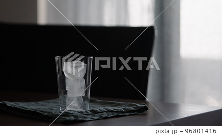 man making iced coffee with milk in thumbler glass on walnut table man making iced coffee with milk in thumbler glass on walnut table 96801416
