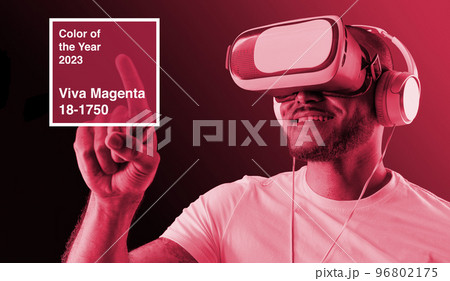 man wearing VR glasses. Color of the year 2023, viva magenta. man wearing VR glasses. Color of the year 2023, viva magenta. 96802175
