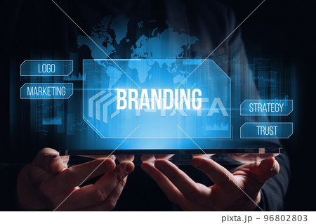 Branding concept. Hologram with a display with a choice of options over a tablet in the hands of a person Branding concept. Hologram with a display with a choice of options over a tablet in the hands of a person 96802803