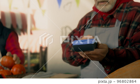Farmer using a payment terminal 96802864