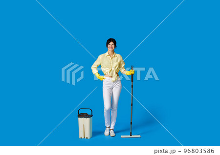 woman in rubber gloves with cleaning supplies 96803586
