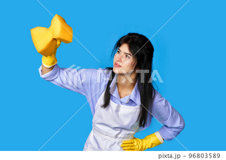 woman in gloves and cleaner apron with detergent sprayer woman in gloves and cleaner apron with detergent sprayer 96803589