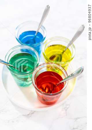 Coloring hard-boiled white eggs with natural food coloring. 96804937