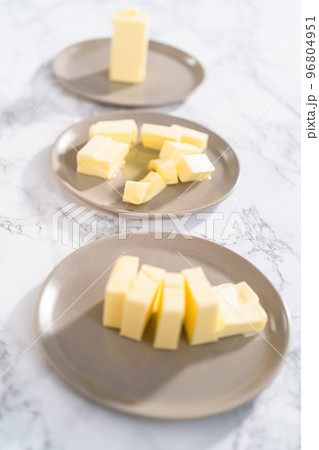 Softened sticks of unsalted butter on the counter. Softened sticks of unsalted butter on the counter. 96804951