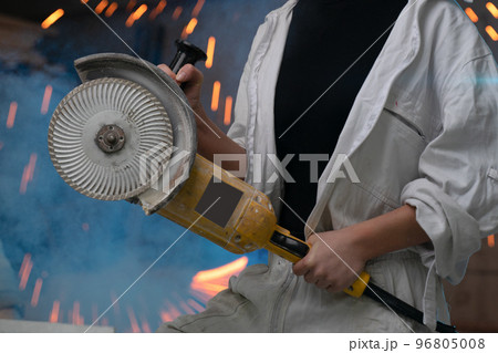 girl working in manufacturing industry job using industrial power tool - Maintenance, production and career concept. worker with angle grinder close-up . feminism. plant, factory girl working in manufacturing industry job using industrial power tool - Maintenance, production and career concept. worker with angle grinder close-up . feminism. plant, factory 96805008