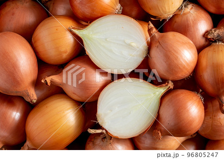 cut onion on a bunch of yellow onions close-up 96805247