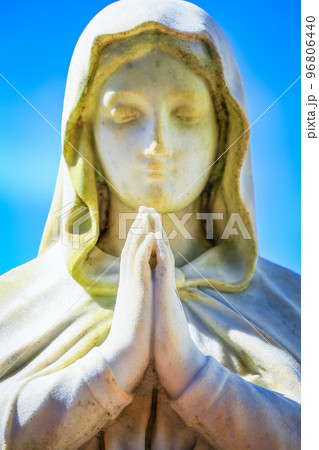 Faithfull Virgin Mary with praying hands and blessing, looking at the sky 96806440