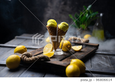 fresh lemon citrus sorbet or ice cream with chopped fresh fruit on the wooden table on the background fresh lemon juice and vase with flowers in a fume. still life ice cream, juice, wood, fume fresh lemon citrus sorbet or ice cream with chopped fresh fruit on the wooden table on the background fresh lemon juice and vase with flowers in a fume. still life ice cream, juice, wood, fume 96806614