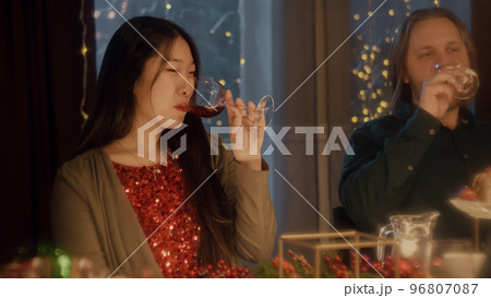 Friends clink glasses celebrating Christmas Friends clink glasses celebrating Christmas 96807087