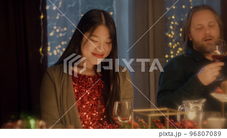 Friends clink glasses celebrating Christmas Friends clink glasses celebrating Christmas 96807089