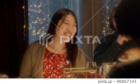Asian woman drinks wine at Christmas party 96807143