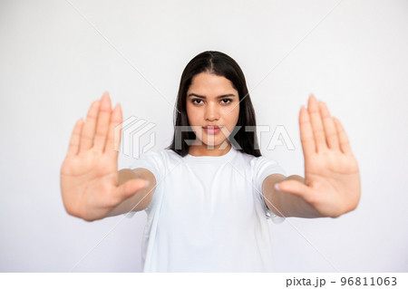 Portrait of serious young woman making denial gesture 96811063