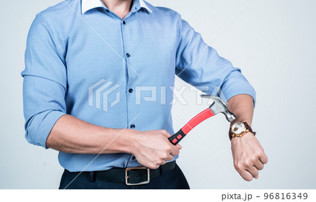 Man cropped view break wrist watch with hammer, beat the clock 96816349