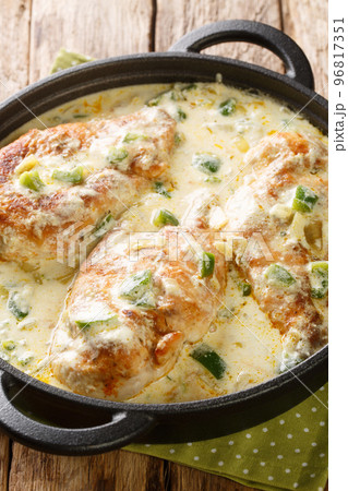 Pollo a la crema or creamed chicken is a South American dish consisting of tender chicken and veggies in a flavorful cream sauce closeup in the pan. Vertical Pollo a la crema or creamed chicken is a South American dish consisting of tender chicken and veggies in a flavorful cream sauce closeup in the pan. Vertical 96817351