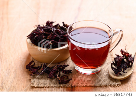 Roselle tea in cup glass with dry roselle on wooden background, Herbal drink Roselle tea in cup glass with dry roselle on wooden background, Herbal drink 96817743