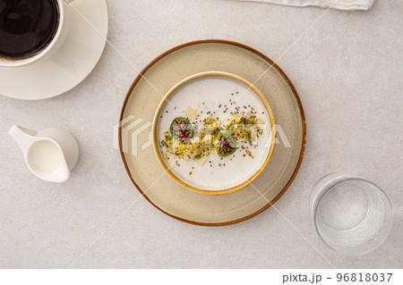 Portion of porridge with pears and herbs 96818037