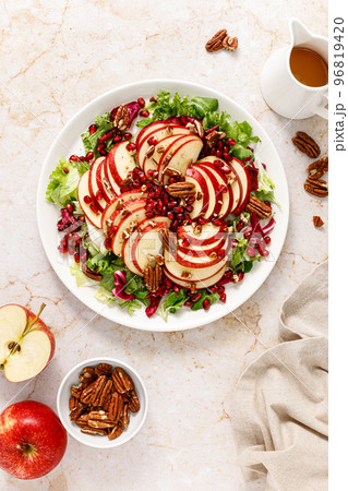 Salad with apple, pomegranate and pecan nut. Healthy food, top view Salad with apple, pomegranate and pecan nut. Healthy food, top view 96819420