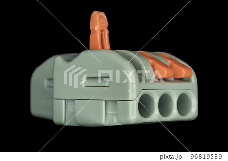 Compact splicing connector isolated on black background. Compact splicing connector isolated on black background. 96819539