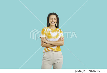 Happy attractive young woman in casual outfit standing isolated on blue background 96820788