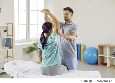 Chiropractor, physiotherapist or osteopath helping young woman during rehabilitation Chiropractor, physiotherapist or osteopath helping young woman during rehabilitation 96820837
