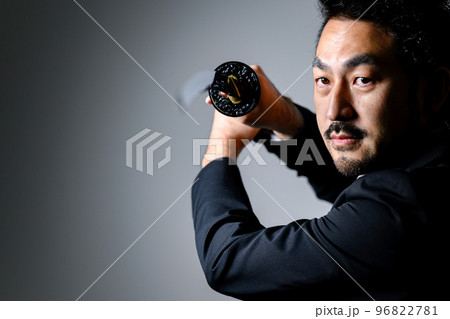 スーツのサラリーマンが刀を持っているところ 96822781