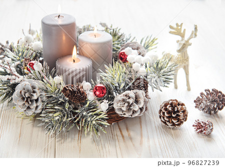 Decorated Advent wreath from fir and evergreen branches with burning candles, tradition in the time before Christmas. Decorated Advent wreath from fir and evergreen branches with burning candles, tradition in the time before Christmas. 96827239