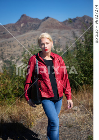 Pretty woman in a mountain park on a sunny day Pretty woman in a mountain park on a sunny day 96827274