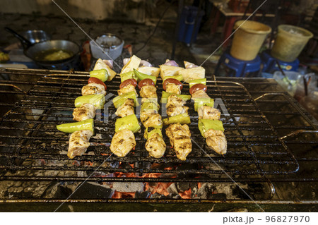 Chicken shish kabob being cooked at outdoor night street market 96827970