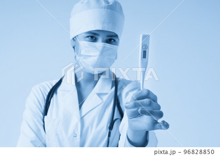 Young female doctor showing thermometer over white background, studio shot Young female doctor showing thermometer over white background, studio shot 96828850