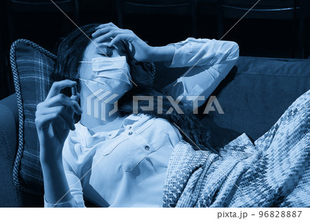 young woman on sofa covered with a blanket freezing blowing running nose got fever, caught, sick girl having influenza symptoms, flu or virus concept 96828887