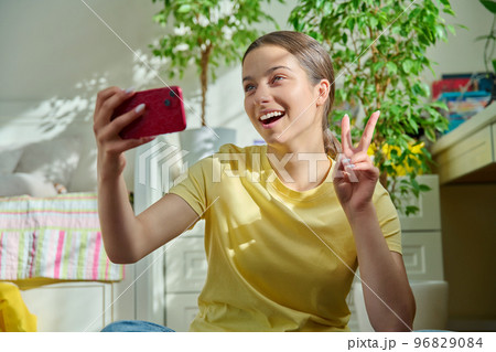 Teenage female using smart phone for conference chat video call Teenage female using smart phone for conference chat video call 96829084