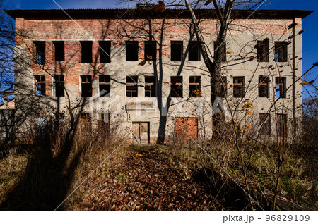 destroyed industrial building from the outside, a three-story industrial building 96829109