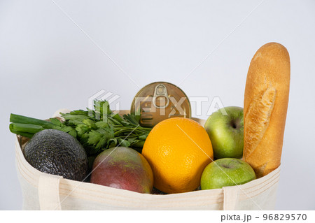 Fabric reusable bag with groceries. An alternative to plastic disposable bags, the theme of ecology 96829570