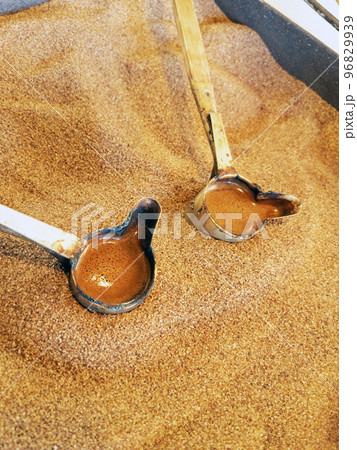 Preparation of natural coffee in Turks on the sand. 96829939