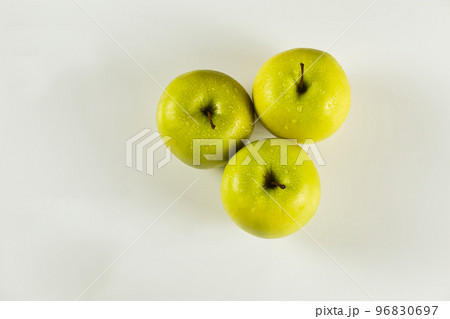 top view of three green apples with drops on white background top view of three green apples with drops on white background 96830697