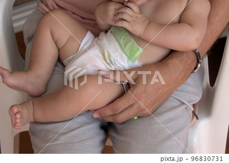 close-up of father holding his lovely baby on his lap close-up of father holding his lovely baby on his lap 96830731
