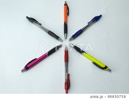 close-up of color pens lined up in a star shape on a white background 96830758