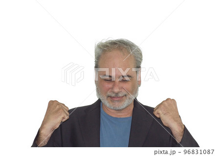foreground portrait of a mature man with a beard celebrating with fist raised on a white background 96831087