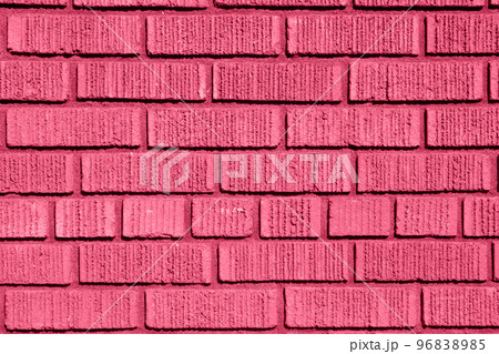 Color of year 2023 Viva Magenta. Image with brick wall is toned in pantone color of viva magenta. New Fashion colour. Old Strong Brickwork. Shabby Building Facade. Perfect Stonework Backdrop. 96838985
