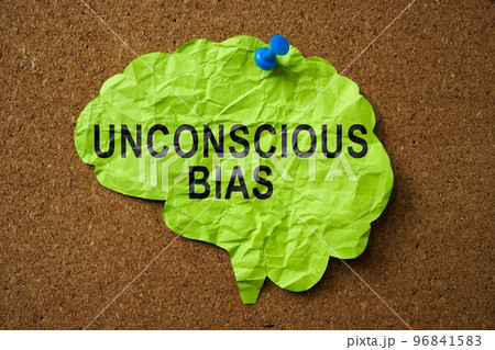 Brain made of paper with the inscription Unconscious Bias pinned to the board. 96841583