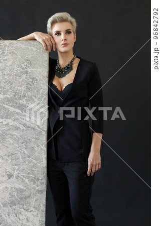 Beautiful woman in black standing near easel Beautiful woman in black standing near easel 96842792