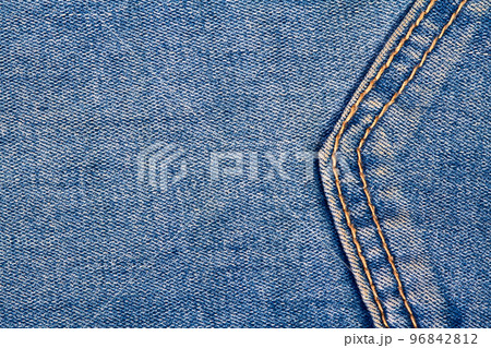 Part of a blue denim jeans background pocket with seam and orange thread stitches Part of a blue denim jeans background pocket with seam and orange thread stitches 96842812