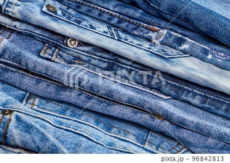 A stack of jeans as denim background or concept of buying, selling, shopping and trendy modern clothes A stack of jeans as denim background or concept of buying, selling, shopping and trendy modern clothes 96842813
